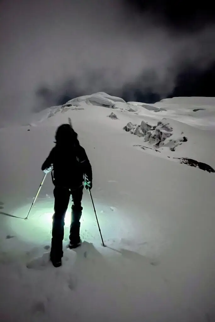 Mountaineer Climbing Cotopaxi under moonlight during summit attempt