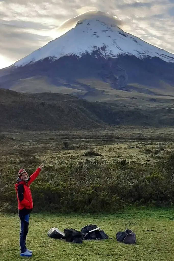 Hiker acclimatizing with Cotopaxi Volcano in the background