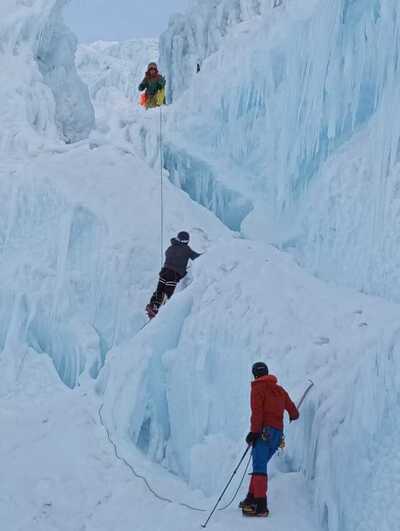 Climbers ascending a snow-capped volcano in the Ecuadorian Andes.